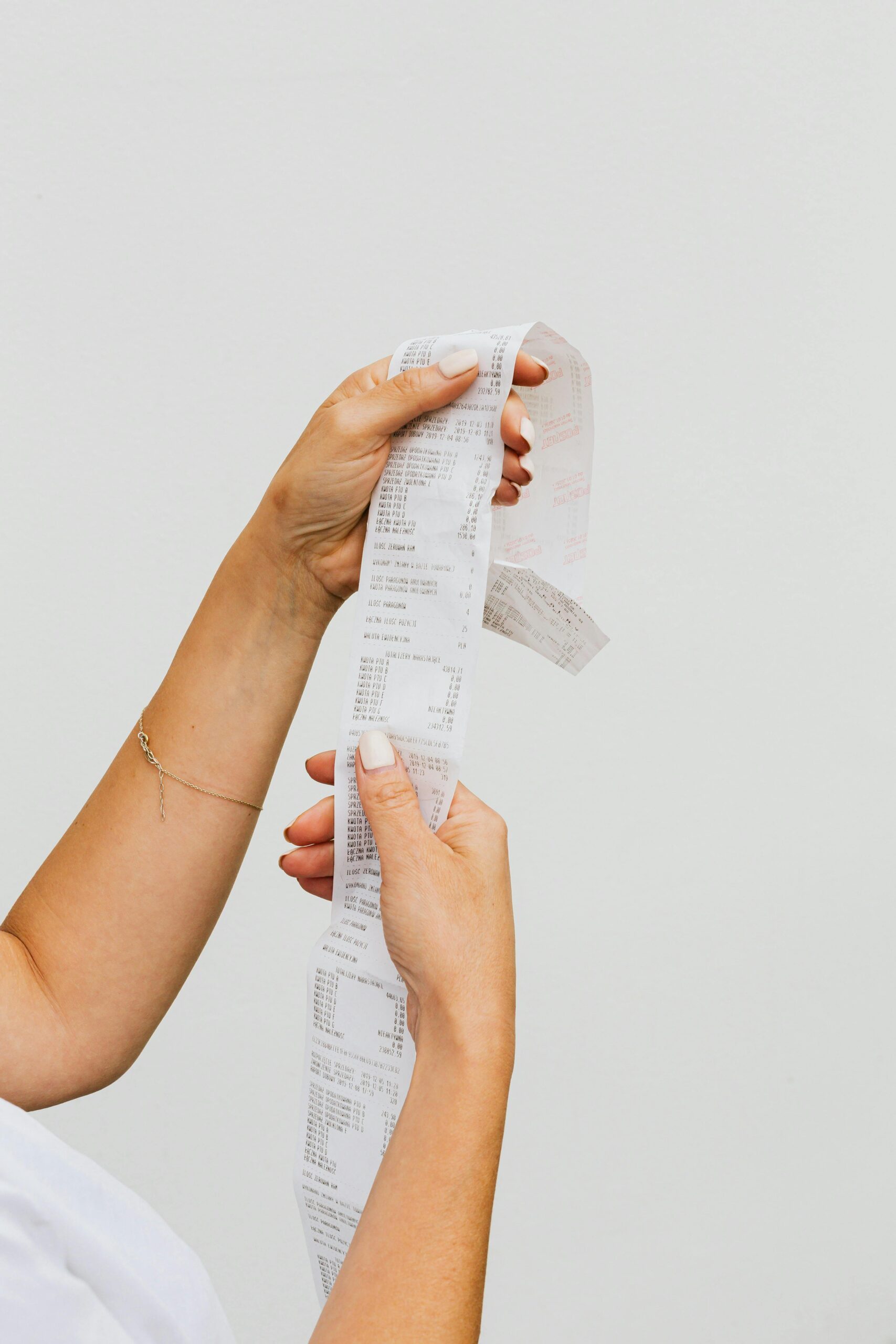 woman holding receipt up to symbolize the list of common website costs